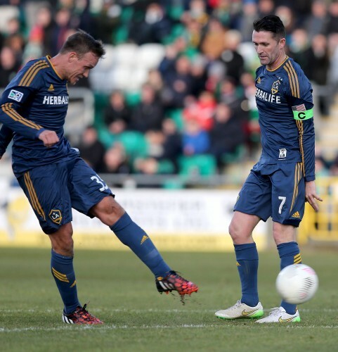 Mika Varynen scores the first goal of the game as Robbie Keane looks on