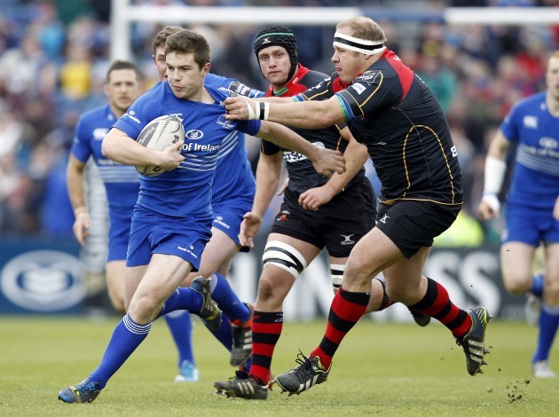 Luke McGrath tries to pass the tackle of Brok Harris