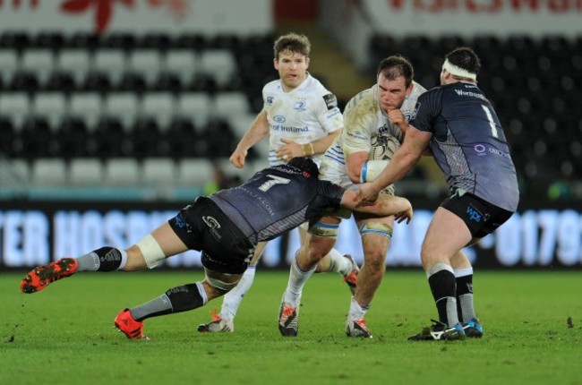 Rhys Ruddock is tackled by James King and Ryan Bevington