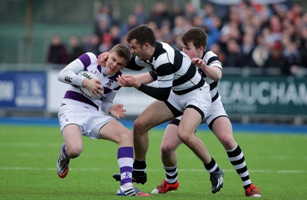 Michael Silvester tackled by Declan Murnaghan and Conor Jennings