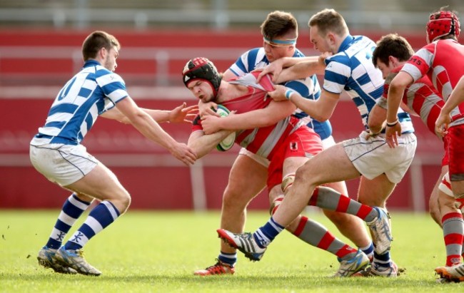 Bill Johnston, James Kendrick and Conor Cashman tackle Ben Clancy