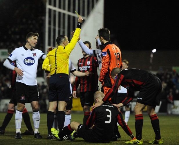 John Mountney is shown a yellow card after clashing with Martin Deady