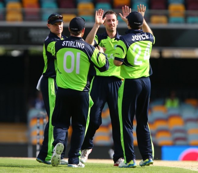 Alex Cusack celebrates with his team after getting the wicket of Rohan Mustafa