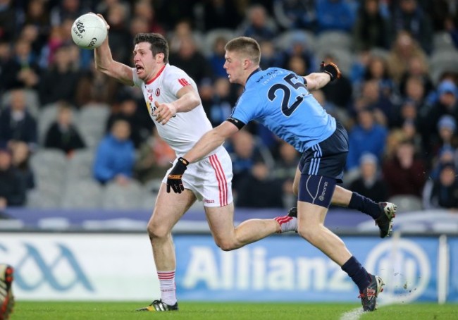 Shane Carthy tackles Sean Cavanagh