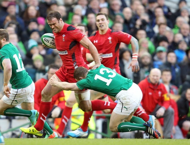 Jamie Roberts breaks the tackle of Brian O'Driscoll