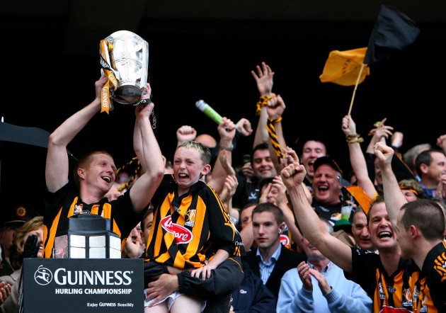 Henry Shefflin celebrates with James McGarry's son Darragh and the cup