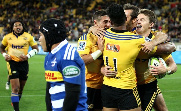 Hurricanes players celebrate Beauden Barrett's try