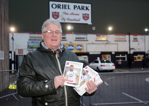 Jimmy Neary sells programs outside the stadium before the match