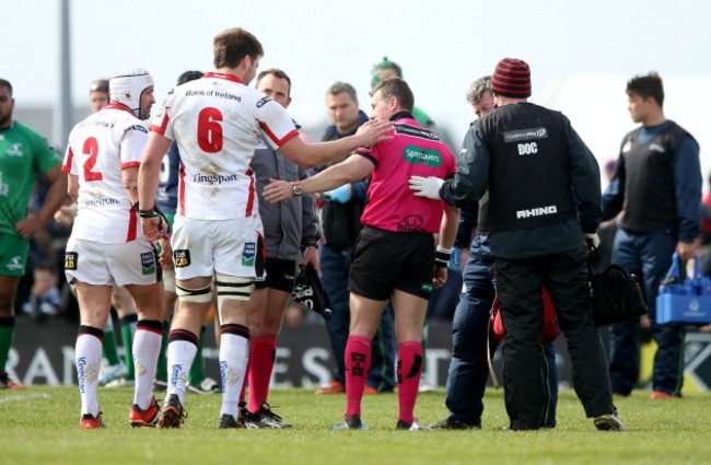 Iain Henderson checks on Nigel Owens  after he got an injury