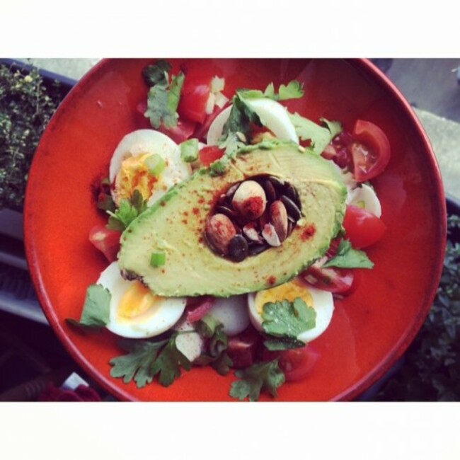 Simple lunch.... 4 boiled eggs -2 yolks/2 whites, 1/2 an avocado, cherry tomatoes, scallions, paprika,parsley and a little nut&used combo. #highfat #naturalbornfeeder