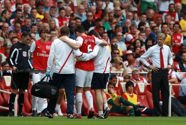 Trouble ahead: an agitated Wenger looks on as Koscielny is carried off