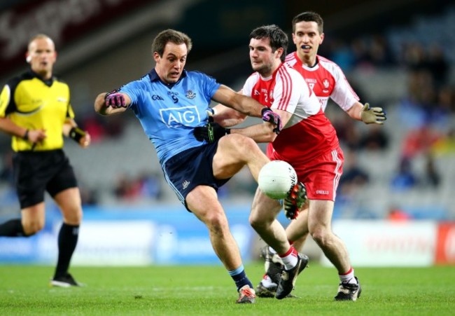 Tomas Brady under pressure from Oisin Duffy