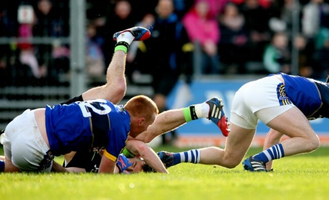 Evan Regan collides with Mark Griffin and Johnny Buckley