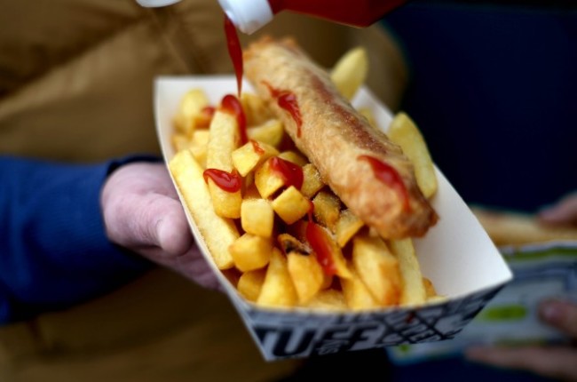 A punter enjoys sausages and chips