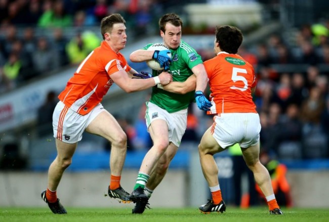 Ciaran O&Otilde;Hanlon and James Morgan tackle Ruairi Corrigan