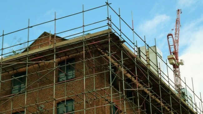 Warehouse buildings under renovation on Hulme Street in Little Ireland, Manchester, UK