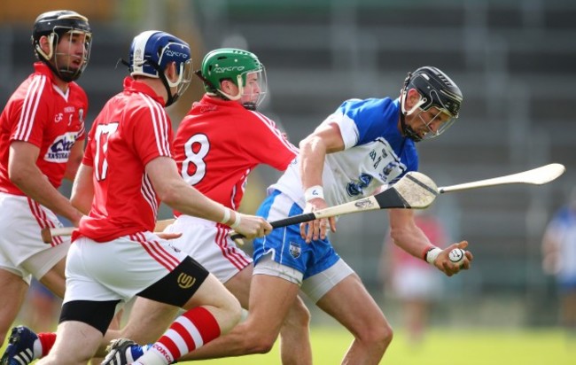 Damien Cahalane, Mark Ellis and Daniel Kearney tackle Maurice Shanahan