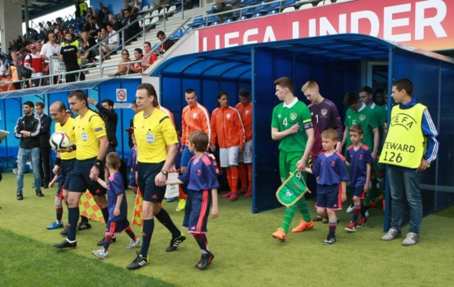 The two teams make their way out to start the game