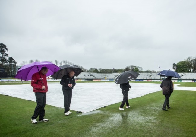 The umpires perform a pitch inspection