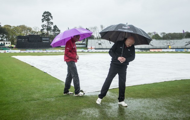 The umpires perform a pitch inspection