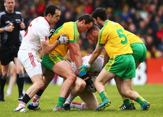 Hugh McFadden, Neil McGee and Ryan McHugh tackle Cathal McShane