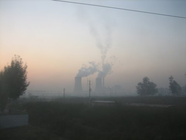Smoking factories along China rail road