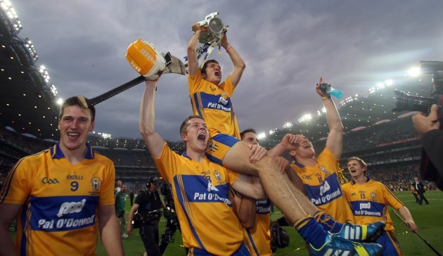 Shane O'Donnell holds the Liam McCarthy Cup while being lifted in front of Hill 16 by team mates