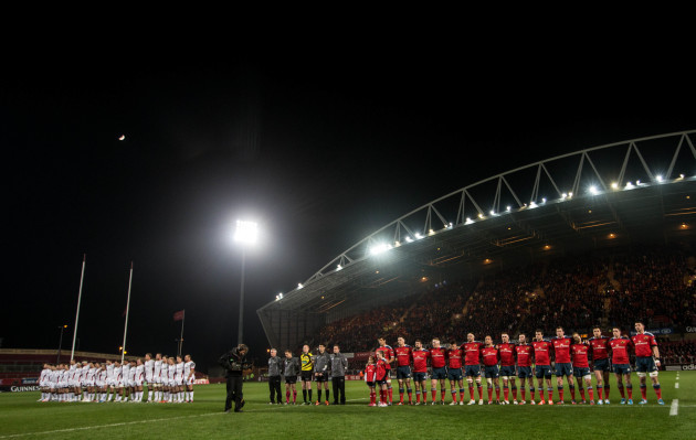 The Ulster and Munster teams observe a minute's silence in memory of Jack Kyle and David McCormick