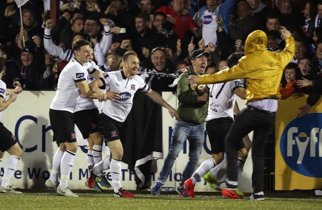 Dundalk fans celebrate on the pitch with goalscorer Stephen O'Donnell
