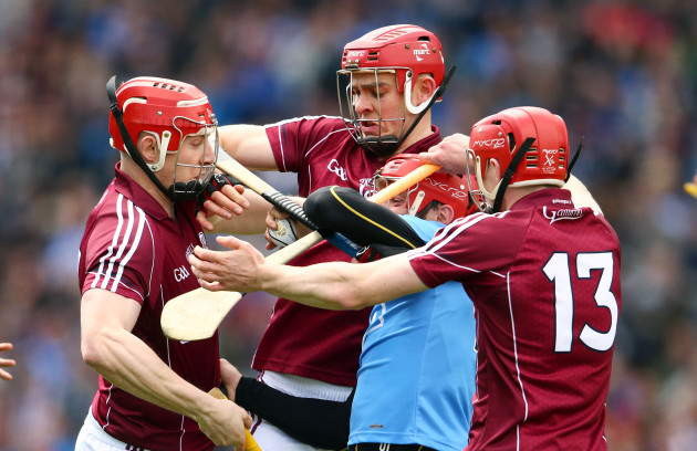 Ryan O’Dwyer is tackled by Joe Canning, Jonathan Glynn and Cathal Mannion