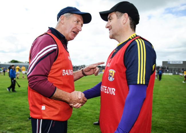 Michael Ryan and Liam Dunne shake hands after the game