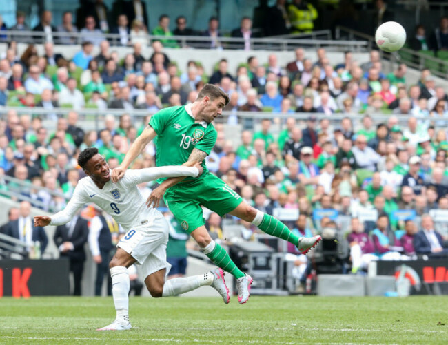 Robbie Brady with Raheem Sterling