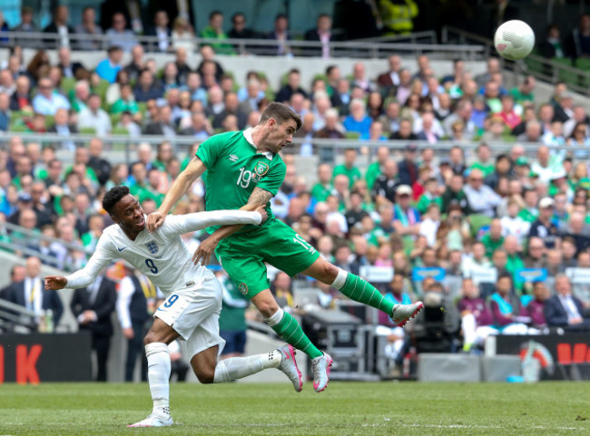 Robbie Brady with Raheem Sterling