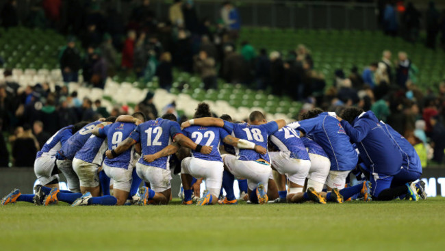 The Samoa team form a huddle after the game