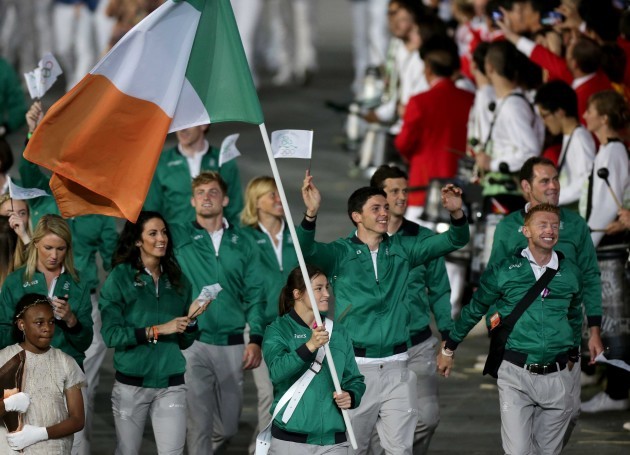 Katie Taylor leads the Irish team holding the flag