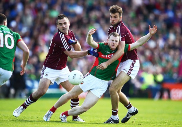 Patrick Sweeney and Paul Conroy tackle Colm Boyle