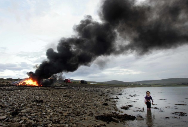Feast of St John. Three-year-old Josephine McHale looks for her dog as a bonfire burns in the background celebrating the Feast of St John today outside of Belmullet, County Mayo. During the Feast many years ago a bull was slaughtered