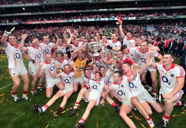 The Cork footballers celebrate with the Sam Maguire