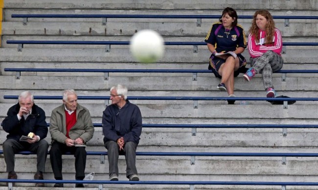 Early arrivals look on from the stands