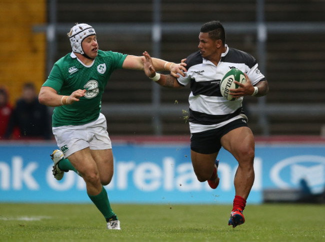 Barbarians David Smith  is tackled by IrelandÕs Luke Marshall