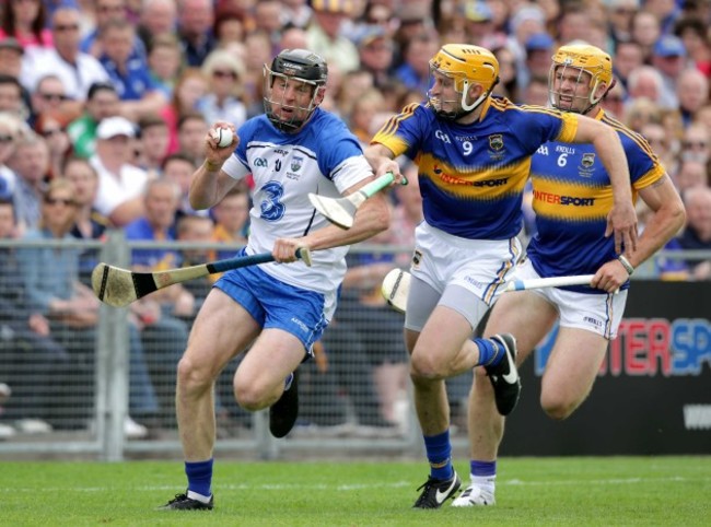 Shane McGrath chases Kevin Moran