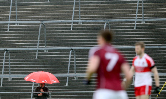 A fan looks on from the terrace