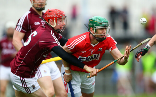 Brian Murphy is tackled by Cathal Mannion