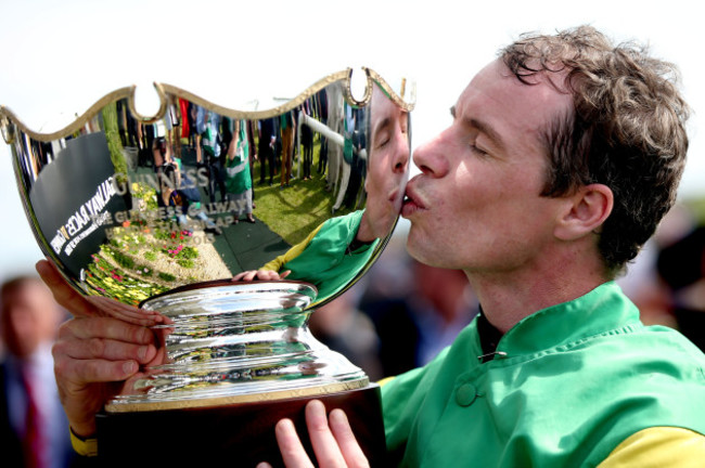 Denis O'Regan celebrates with the trophy after winning