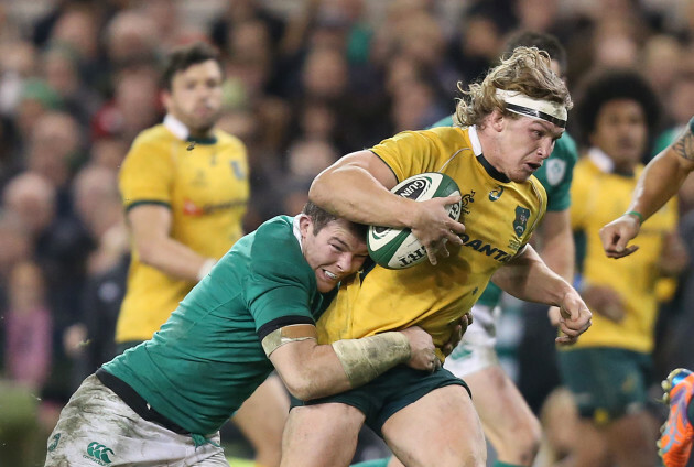 Michael Hooper is tackled by Peter O'Mahony