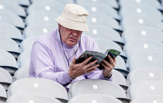 A fan checks his program