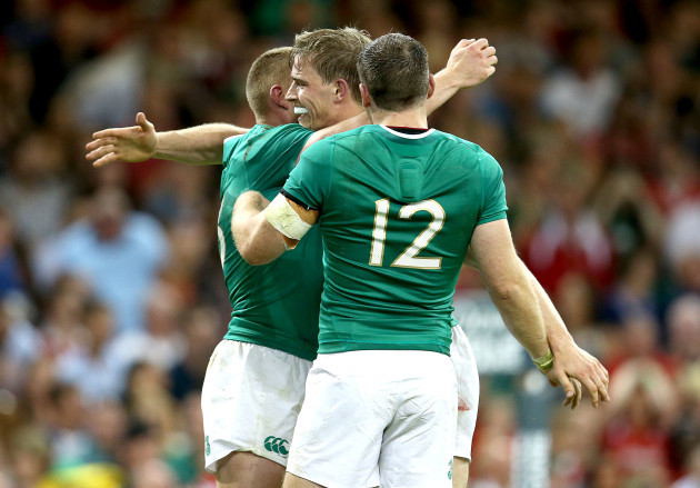 Keith Earls celebrates his try with Darren Cave and Andrew Trimble