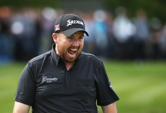 Shane Lowry celebrates holing a birdie putt on the 18th green