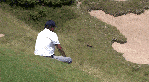 phil-mickelson-sliding-down-a-hill-at-whistling-straits