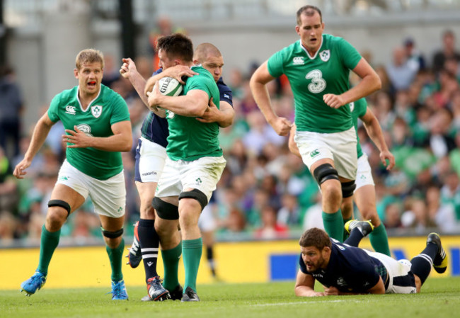 Jack Conan supported by Chris Henry and Devin Toner tackled by Gordon Reid